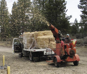 Figure 10.23 - Straw blowers range in size from machines which can apply 30 to 60 bales per hour (shown here) to very large straw blowers that can shoot up to 20 tons per hour.